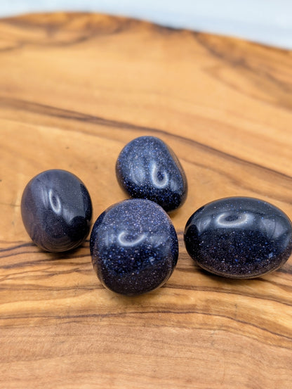 Large polished Blue Sandstone tumbles with deep navy blue color and sparkling metallic flecks