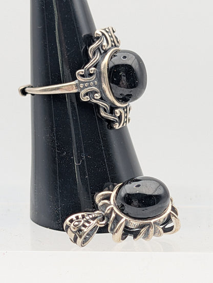 Obsidian pendant and adjustable sterling silver ring showing ornate silver settings