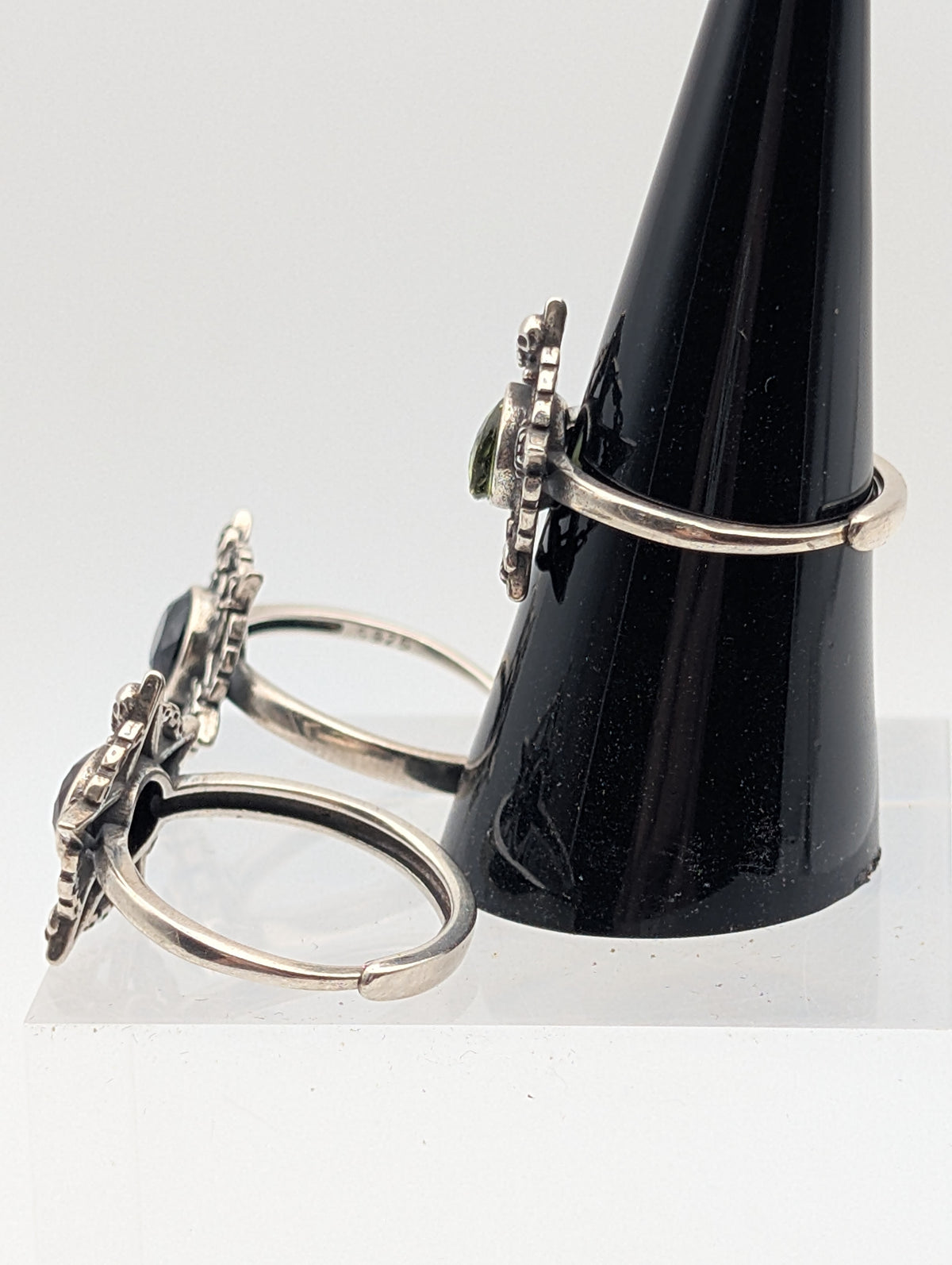 Sterling silver pentagram rings showing open adjustable bands and raised gemstone settings