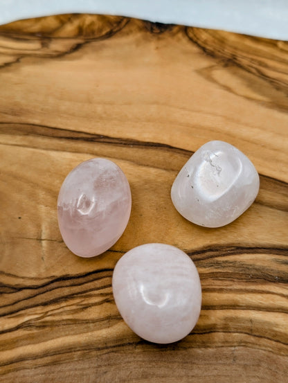 Polished Rose Quartz tumble stones ranging from translucent pale pink to milky blush pink