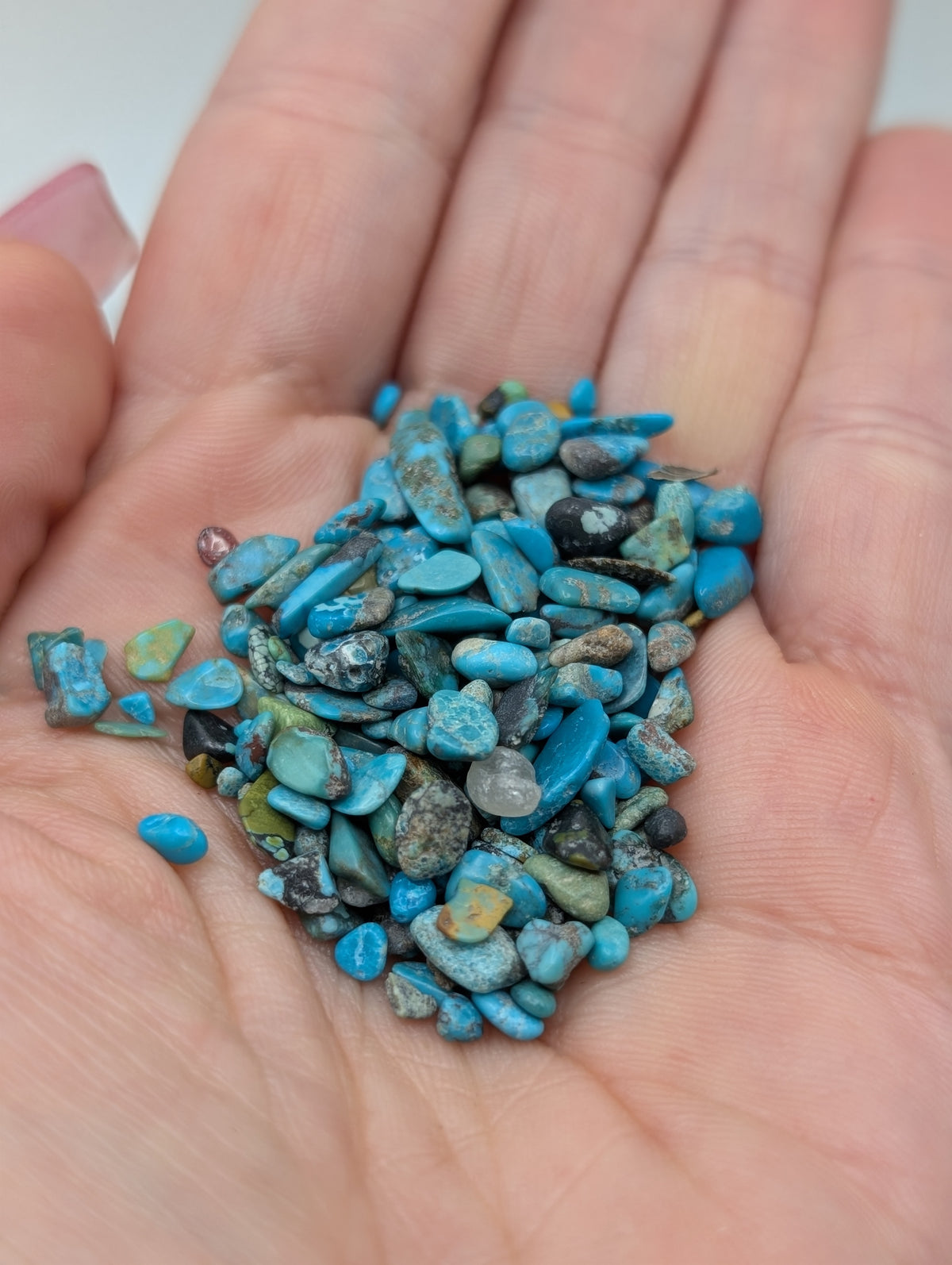 Turquoise stone chips with vivid blue color and natural-looking brown and gray matrix