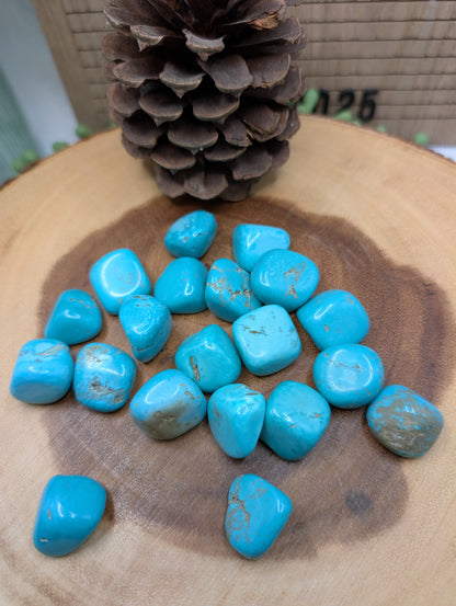 Polished turquoise blue tumble stones with brown and gray matrix patterns