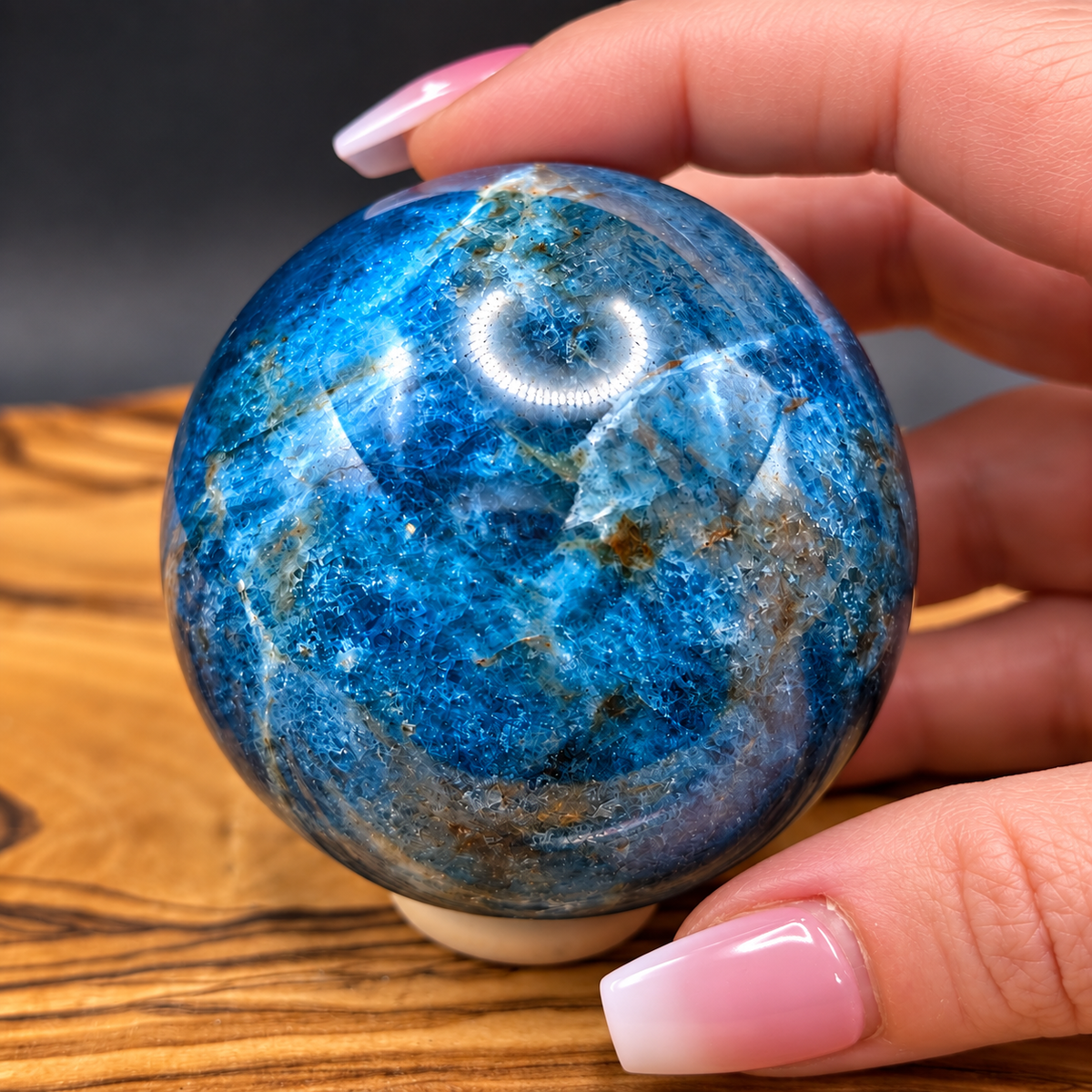 57 mm Blue Apatite crystal sphere showing vivid blue color and natural mineral patterns