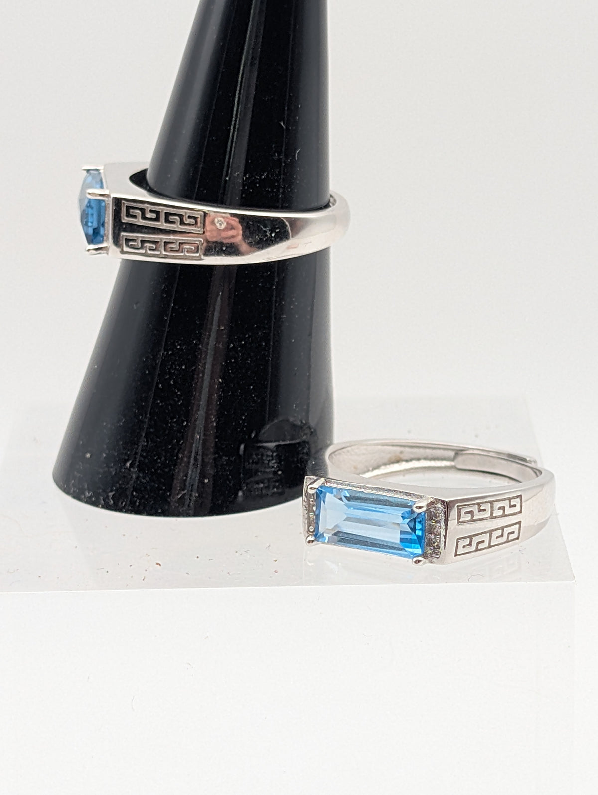 Blue Topaz adjustable sterling silver ring showing rectangular faceted gemstone and open geometric band