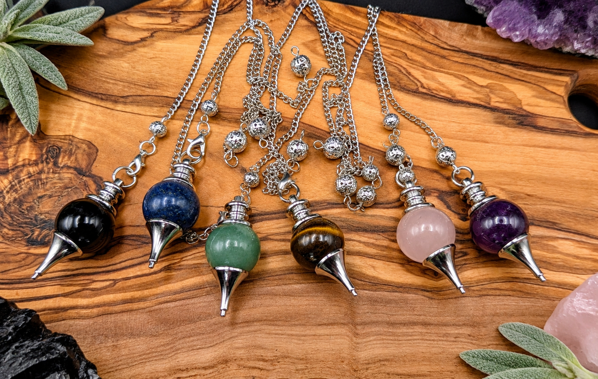 Crystal pendulums in Obsidian, Lapis Lazuli, Green Aventurine, Tiger’s Eye, Rose Quartz and Amethyst with silver metal chains