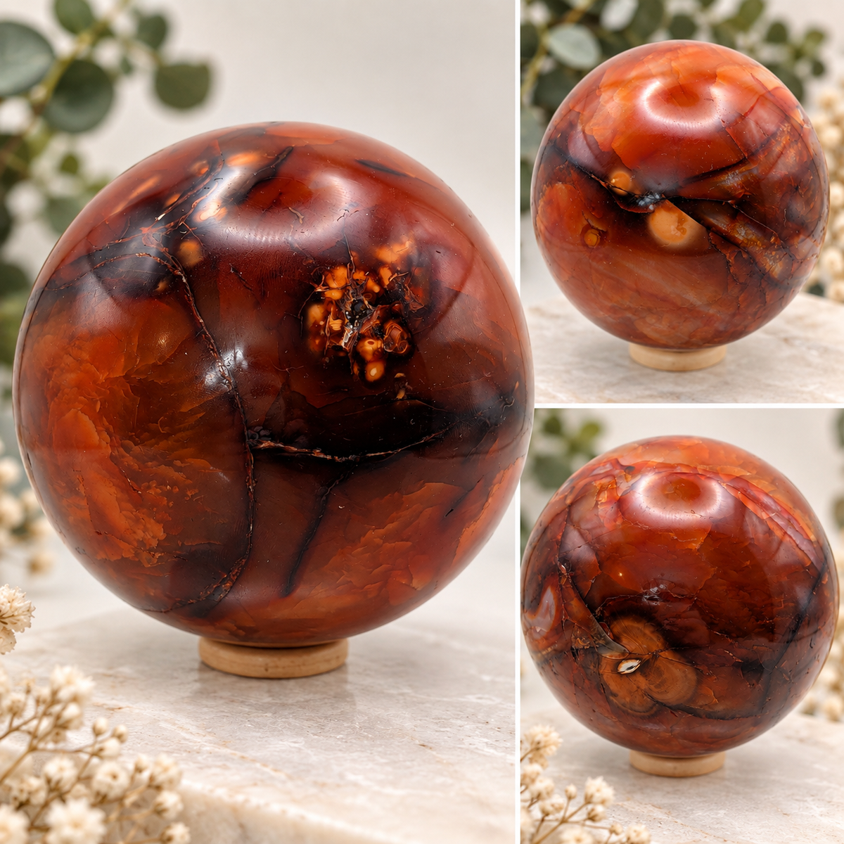 Large 96mm deep red and orange Carnelian crystal sphere with natural patterns displayed on a wooden ring stand